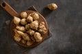 Jerusalem artichoke root, sunchokes on brown table.