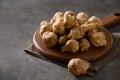 Jerusalem artichoke root, sunchokes on brown table.