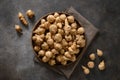 Jerusalem artichoke root, sunchokes on dark brown.