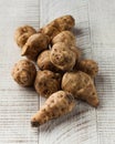 Jerusalem artichoke on a white wooden table. healthy food, vegetables Royalty Free Stock Photo