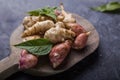 Jerusalem artichokes or topinambour, topinambur, also known as earth apple or sunroot on a cutting board. Dietaryfibre