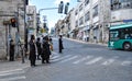 Some Jewish men are waiting for the green light near the road in Jerusalem Royalty Free Stock Photo