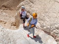 Experienced athletes start the descent with the equipment for snapping in the mountains of the Judean Desert near the Tamarim