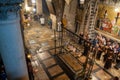 Jerusalem, Israel - 10 April, 2023. Priests, Tourists and pilgrims prayng at the Stone of Anointing in the church of holy