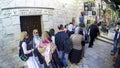 Tourist visiting Jerusalem on old City stone alley street in front of Old door