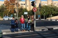 Jerusalem, Israel - December 1, 2013: Arab children wait for green light at a pedestrian crossing on Hayim Barlev avenue in East Royalty Free Stock Photo