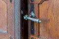 Decorative bronze handle on the front door in the interior of the Benedictine Abbey of Abu Gosh in the Chechen village Abu Ghosh