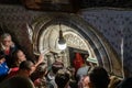 Numerous pilgrims and tourists stand at the entrance to the Christmas Cave in the Church of Nativity in Bethlehem in Palestine Royalty Free Stock Photo