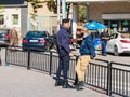 Palestinian policeman and Palestinian guard stand and talk in the central square of Bait Sahour - a suburb of Bethlehem in