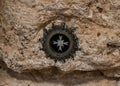 White marble cross in silver frame inserted into stone in the Milk Grotto Church in Bethlehem in Palestine