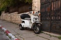 Evening view of an old small scooter standing on Benjamin Disraeli Street in the old Jerusalem district Talbia - Komiyum in