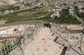 Tourists climb the steps of the restored staircase to the ruins of the palace of King Herod - Herodion in the Judean Desert,