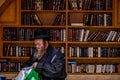 23/11/2016 Jerusalem, Israel, Jews sit near shelves with religious books on the square