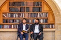 23/11/2016 Jerusalem, Israel, Jews sit near shelves with religious books on the square