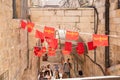 Decoration in red flags with Armenian symbols hanging on ropes on the quiet small Ararat Street in the Armenian quarter in the old