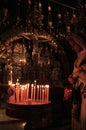 A female pilgrim prays at the altar of Golgotha.