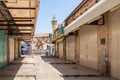 Street on the Arab market Suq Aftimos with closed shops leading to the fountain on Muristan Square in the old city of Jerusalem,