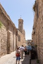 Tourists walk and explore the Lion Gate Street and Monastery of the Flagellation on it in the Arab Quarter in the old city of