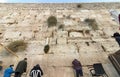 A low-angle view of people praying near the stones of the Western Wall in Jerusalem, Israel Royalty Free Stock Photo