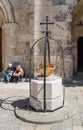 Decorative flower bed framed with a metal frame with a cross in the courtyard of Pools of Bethesda in the old city of Jerusalem, I Royalty Free Stock Photo