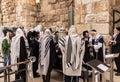 A group of Orthodox believers Jews conduct a joint prayer with the Torah Scrolls near the Kotel in the Old Town of Jerusalem in Royalty Free Stock Photo