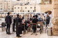 A group of Orthodox believers Jews conduct a joint prayer with the Torah Scrolls near the Kotel in the Old Town of Jerusalem in Royalty Free Stock Photo