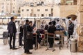 A group of Orthodox believers Jews conduct a joint prayer with the Torah Scrolls near the Kotel in the Old Town of Jerusalem in Royalty Free Stock Photo