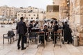 A group of Orthodox believers Jews conduct a joint prayer with the Torah Scrolls near the Kotel in the Old Town of Jerusalem in Royalty Free Stock Photo