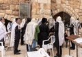 A group of Orthodox believers Jews conduct a joint prayer with the Torah Scrolls near the Kotel in the Old Town of Jerusalem in Royalty Free Stock Photo