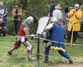 Two knights with shields and swords fight in the ring at the Purim festival with King Arthur in the city of Jerusalem, Israel