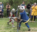 Two knights with shields and swords fight in the ring at the Purim festival with King Arthur in Jerusalem city, Israel