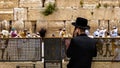 An Orthodox Jew uses a cell phone in front of the Western Wall in Jerusalem