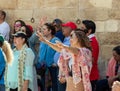 Believer lifts her hands to heaven during group prayer in the courtyard of the Chapel of the Ascension on Mount Eleon - Mount of