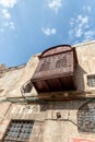 Decorative wooden external balcony on the wall of a building on the Shaar ha-Shalshelet Street in the old city of Jerusalem in