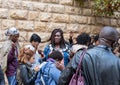 A group of pilgrims believers make a mass prayer near the outer walls of Dormition Abbey in old city of Jerusalem, Israel