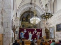 The guide tells visitors about St. Mark`s Church - The Syrian Orthodox Church in old city of Jerusalem, Israel