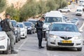 Israeli police officer checks documents of a driver of a private car near a Dung Gate in the old city of Jerusalem in Israel