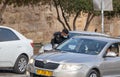 Israeli police officer checks documents of a driver of a private car near a Dung Gate in the old city of Jerusalem in Israel