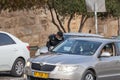 Israeli police officer checks documents of a driver of a private car near a Dung Gate in the old city of Jerusalem in Israel