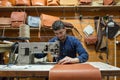 Israel based male leather artisan making custom leather bags in a small shop in old city of Jerusalem, Israel