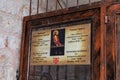 The sign with opening hours on the door of the Prison of Christ in the Greek Orthodox monastery on Via Dolorosa Street in the old