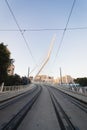 The railway tracks of the light rail in Jerusalem against the background of the famous string bridge at the entrance to the city Royalty Free Stock Photo