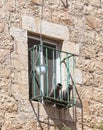 Antique clay jugs lie on a metal grate outside the window in the Old City in Jerusalem, Israel