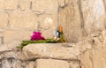 Candles and flowers lie on a ritual stone near the wall of the Temple Mount near the Dung Gate in the Old City in Jerusalem, Royalty Free Stock Photo