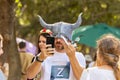A festival goer tries on a DIY felt mask with horns at the Knights of Jerusalem Festival at the Ein Yael Museum, in Jerusalem,