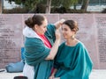 The make-up artist makes makeup for the model before shooting at Mt. Scopus in Jerusalem in Israel