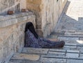 Muslim woman sits on the steps and asks for alms near the Dome of the Rock building in the Old City in Jerusalem, Israel Royalty Free Stock Photo