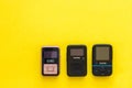 Three black mp3 players on a yellow background