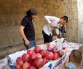 JERUSALEM, ISRAEL. Young people wring out and sell garnet juice on the street