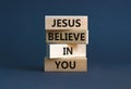 Jesus believe in you symbol. Concept words `Jesus believe in you` on wooden blocks on a beautiful grey background. Businessman